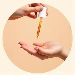 Image illustrating applying serum drops to fingertips
